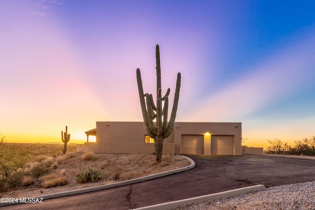 pueblo-style home featuring a garage