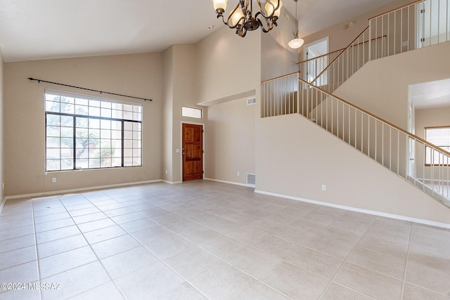 foyer entrance with stairway, visible vents, baseboards, an inviting chandelier, and light tile patterned flooring