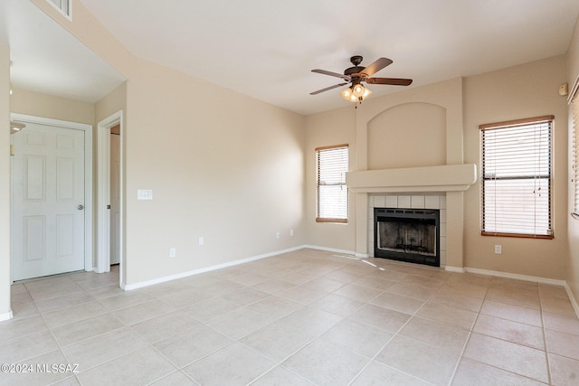 unfurnished living room featuring light tile patterned floors, a fireplace, and baseboards