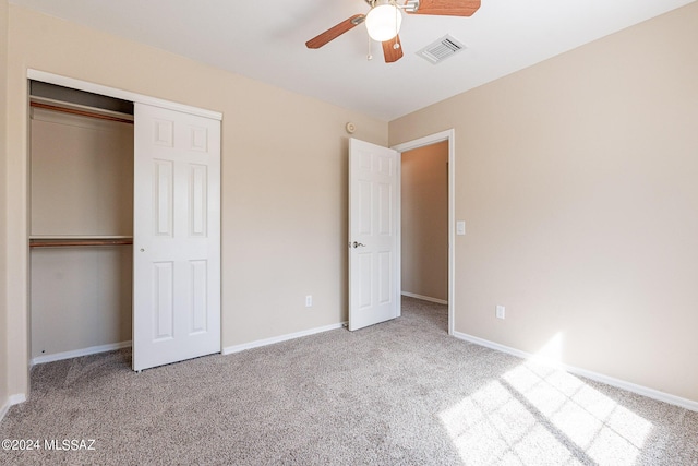 unfurnished bedroom featuring baseboards, a closet, carpet floors, and visible vents