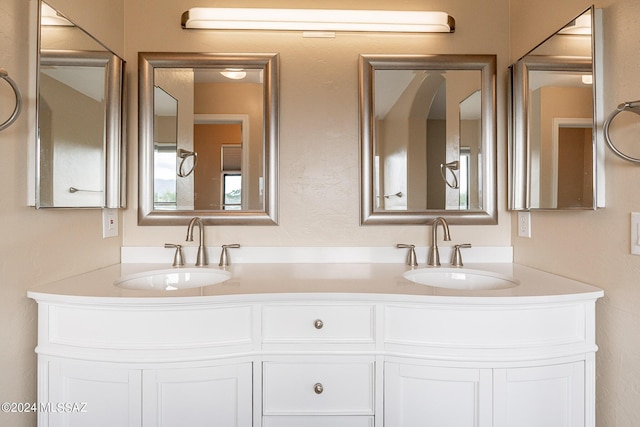 full bath with double vanity and a sink