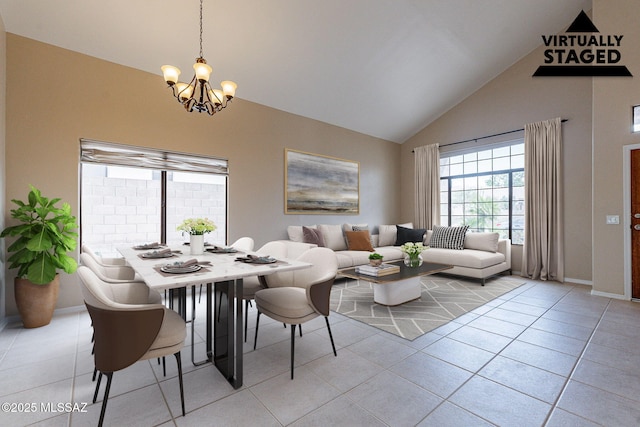 dining space featuring light tile patterned floors, a notable chandelier, high vaulted ceiling, and baseboards