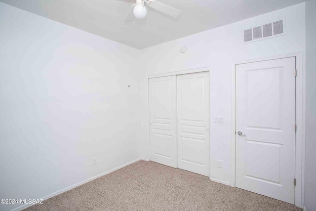 unfurnished bedroom featuring carpet floors and ceiling fan