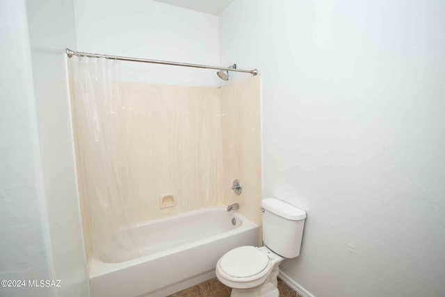 bathroom with toilet and shower / bath combo with shower curtain