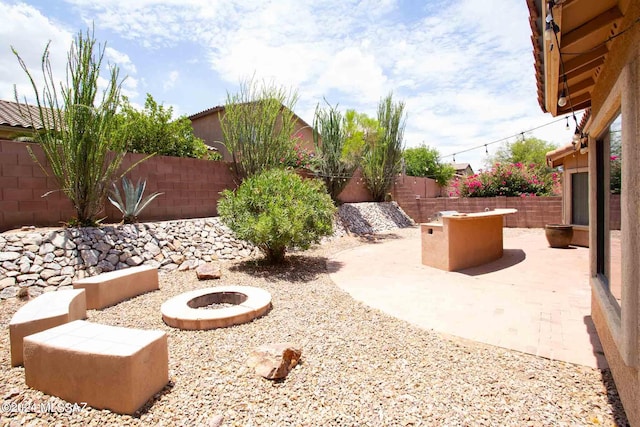 view of yard featuring a patio area and a fire pit