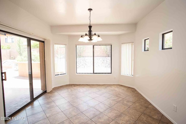 unfurnished dining area featuring an inviting chandelier and tile patterned flooring