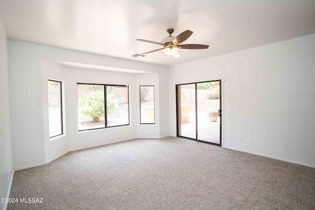 unfurnished room with ceiling fan and carpet