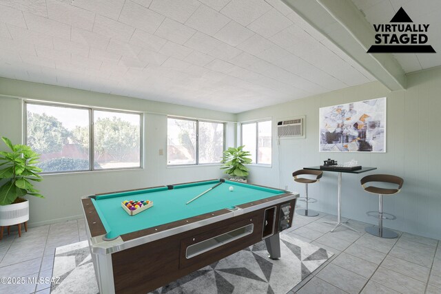 game room with a wall mounted air conditioner, beam ceiling, billiards, and light tile patterned floors