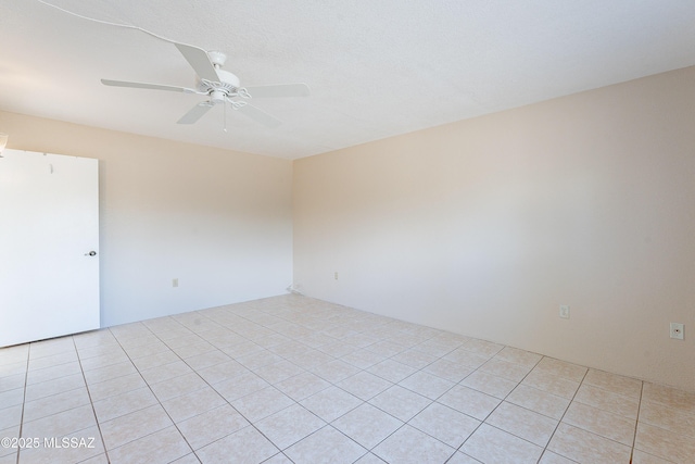 empty room with light tile patterned flooring and ceiling fan