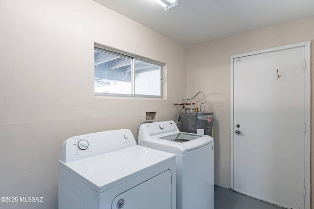 washroom featuring water heater and washer and clothes dryer