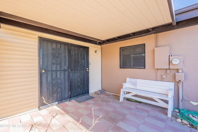 entrance to property featuring a patio