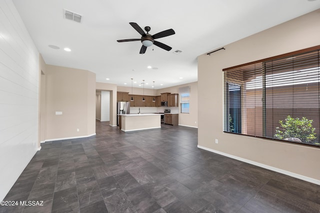 unfurnished living room featuring ceiling fan