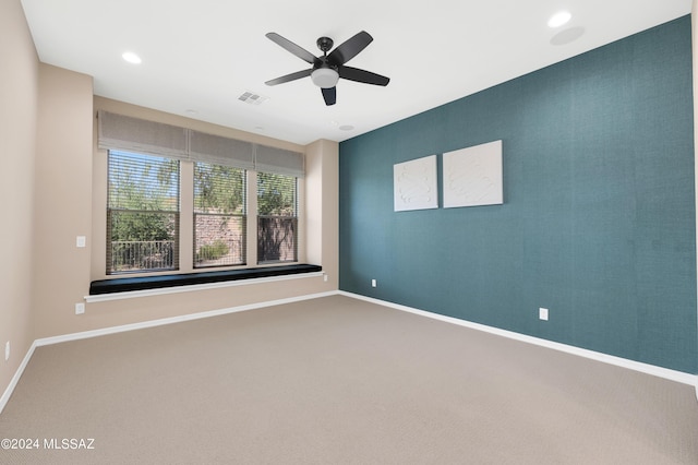 unfurnished room featuring carpet floors and ceiling fan