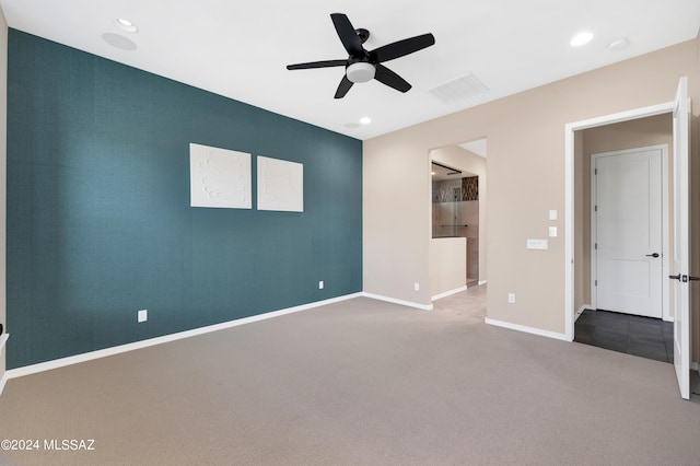 spare room featuring carpet and ceiling fan