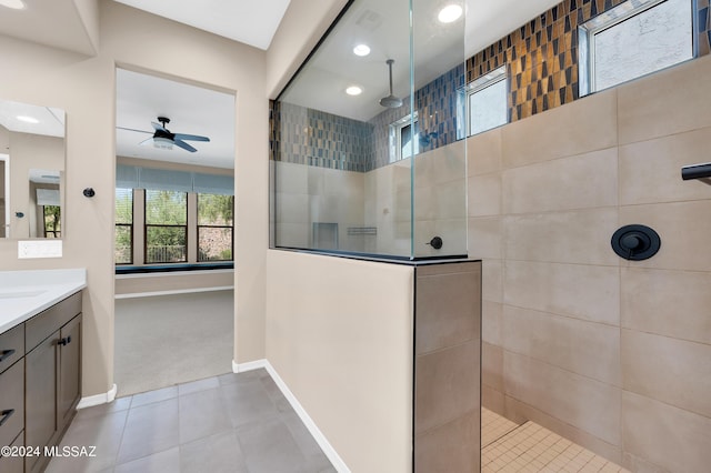 bathroom with vanity, ceiling fan, tile patterned floors, and tiled shower