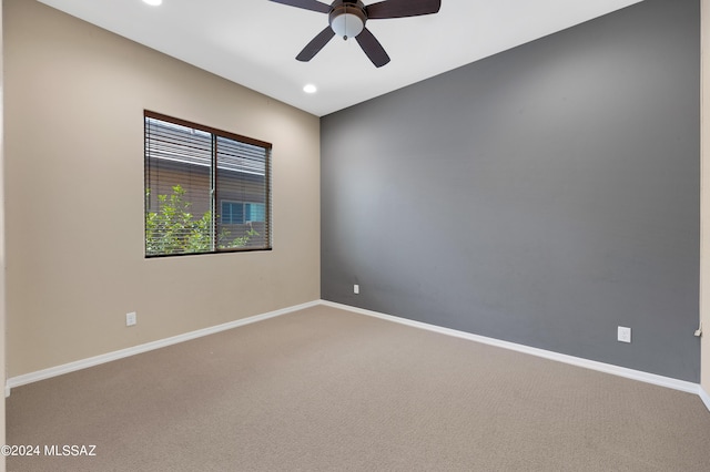 empty room featuring ceiling fan and carpet