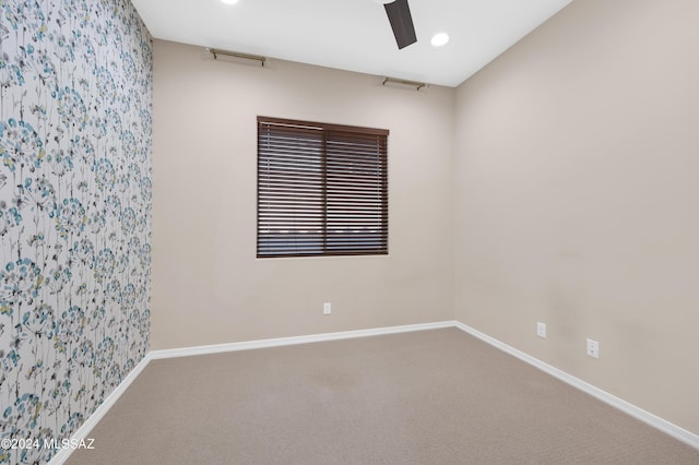 empty room with ceiling fan and carpet flooring