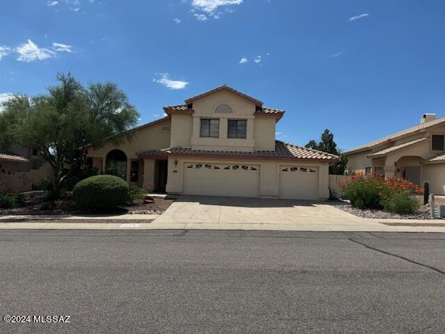 mediterranean / spanish-style home with a garage