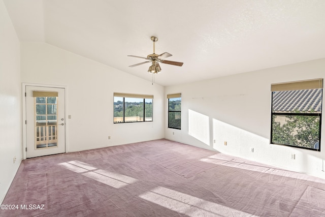 carpeted empty room featuring ceiling fan and vaulted ceiling