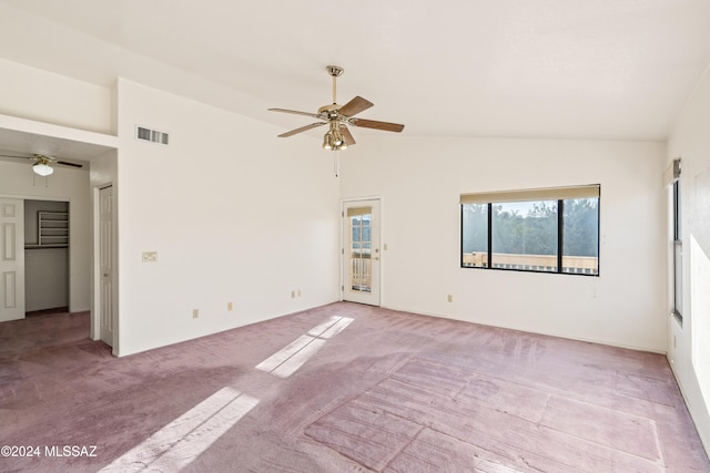 carpeted empty room featuring ceiling fan and high vaulted ceiling