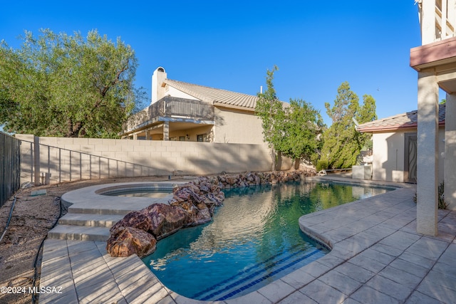 view of swimming pool with a patio area and an in ground hot tub