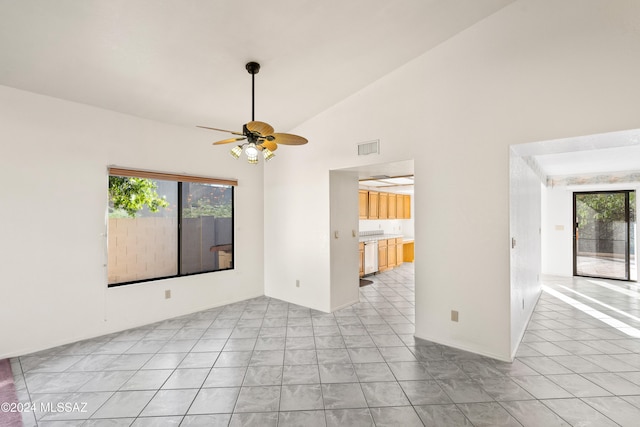 tiled spare room with ceiling fan and vaulted ceiling