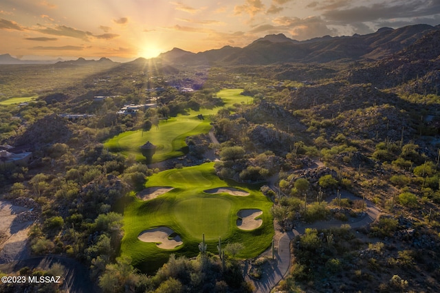 aerial view at dusk featuring a mountain view