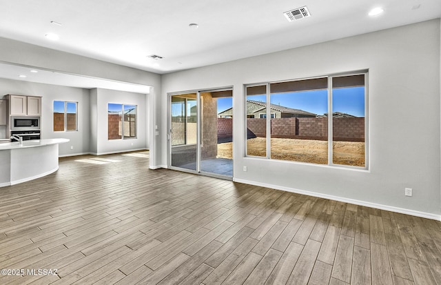 unfurnished living room with wood-type flooring