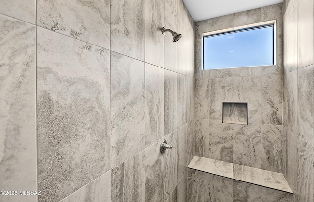 bathroom with tiled shower