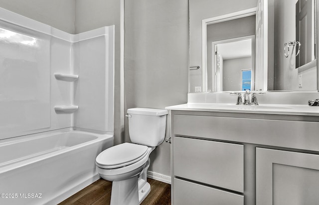 full bathroom featuring hardwood / wood-style flooring, vanity, toilet, and bathing tub / shower combination