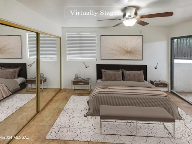 tiled bedroom featuring ceiling fan and a closet