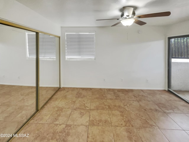 unfurnished bedroom featuring ceiling fan, a closet, and light tile patterned floors