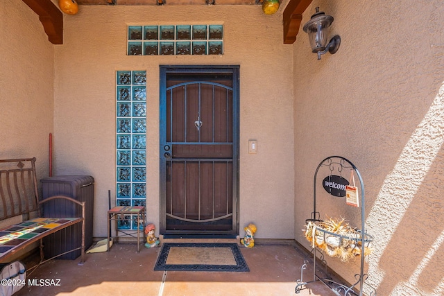 entrance to property featuring stucco siding