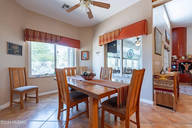 dining room with visible vents, ceiling fan, baseboards, and light tile patterned floors