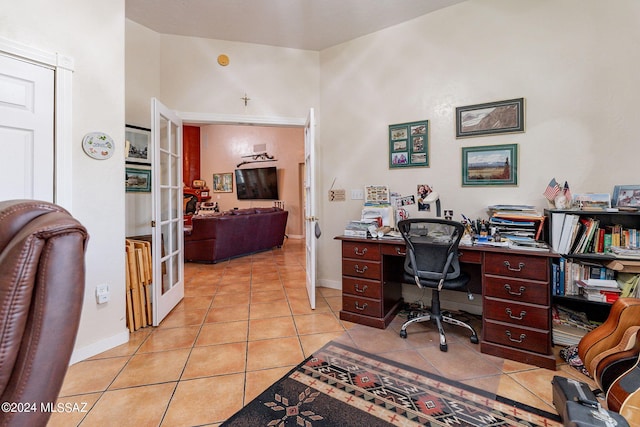 office space with french doors, baseboards, and tile patterned floors