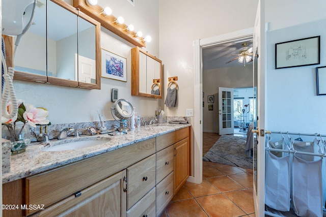 full bath with double vanity, french doors, a sink, and tile patterned floors