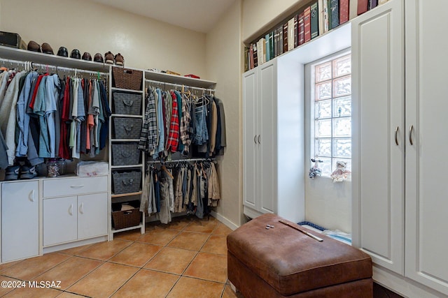 walk in closet with light tile patterned flooring