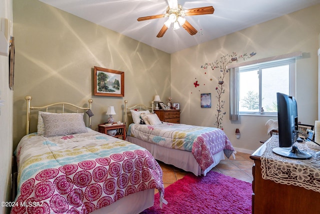 bedroom featuring ceiling fan, baseboards, and tile patterned floors