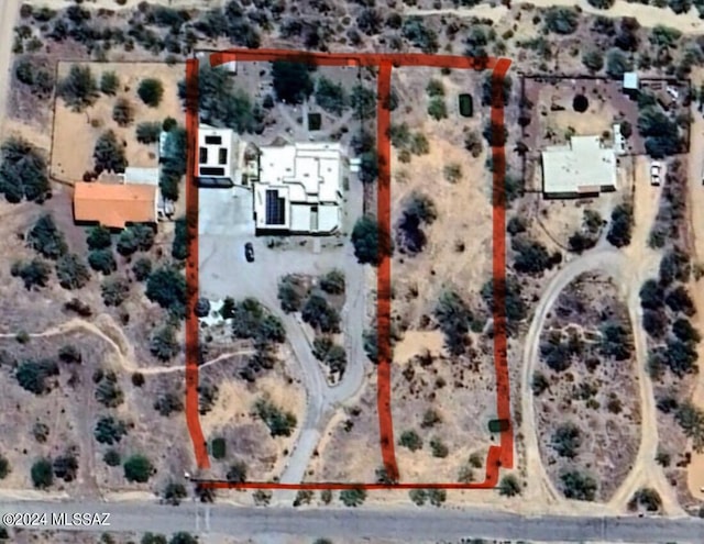 birds eye view of property with a desert view and a rural view