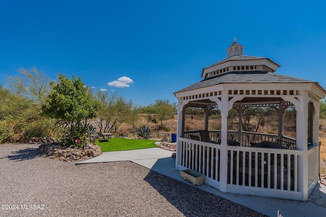 view of community featuring a gazebo, a yard, and a patio