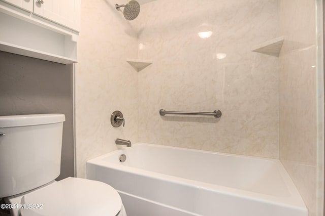 bathroom with tiled shower / bath combo and toilet