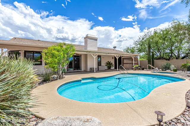 view of swimming pool with a patio area