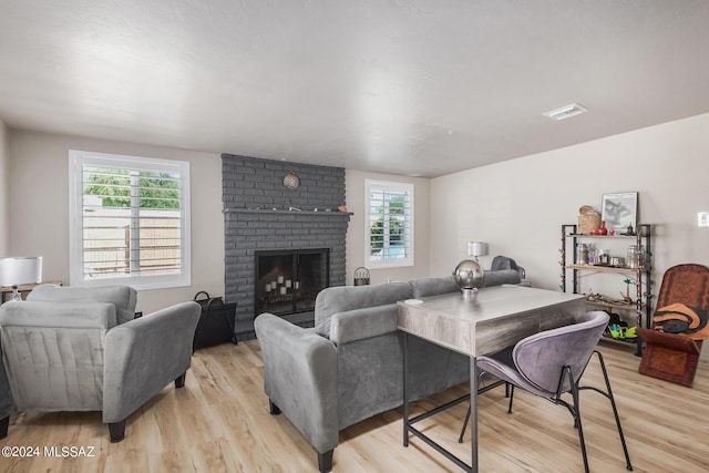 living room featuring a fireplace and light hardwood / wood-style flooring