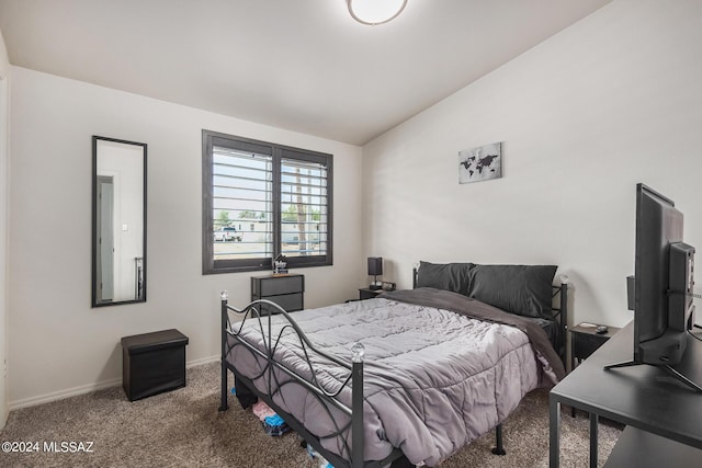 carpeted bedroom with lofted ceiling