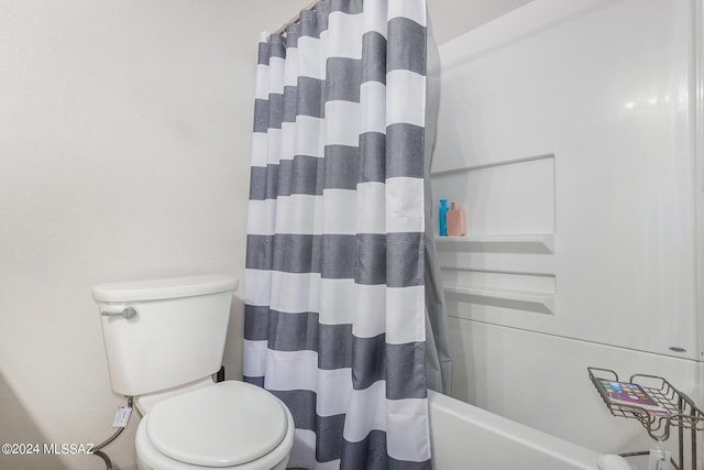 bathroom featuring toilet and shower / bath combo with shower curtain