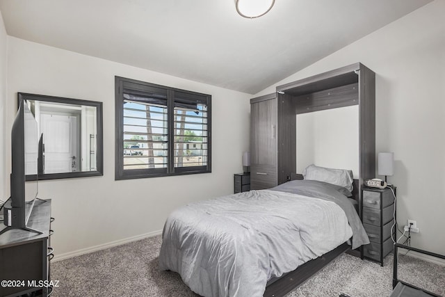 carpeted bedroom with lofted ceiling