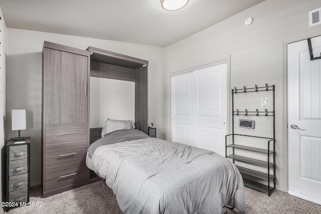 carpeted bedroom with vaulted ceiling and a closet