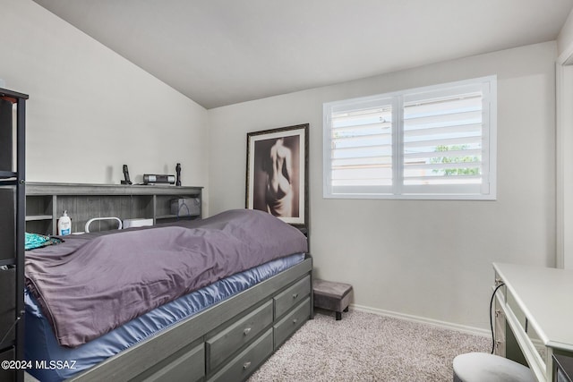 bedroom with vaulted ceiling and light carpet