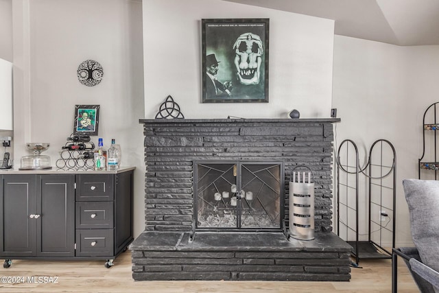 room details with a brick fireplace and wood-type flooring