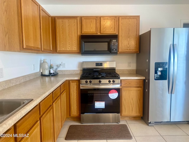 kitchen featuring light tile patterned floors, sink, and appliances with stainless steel finishes